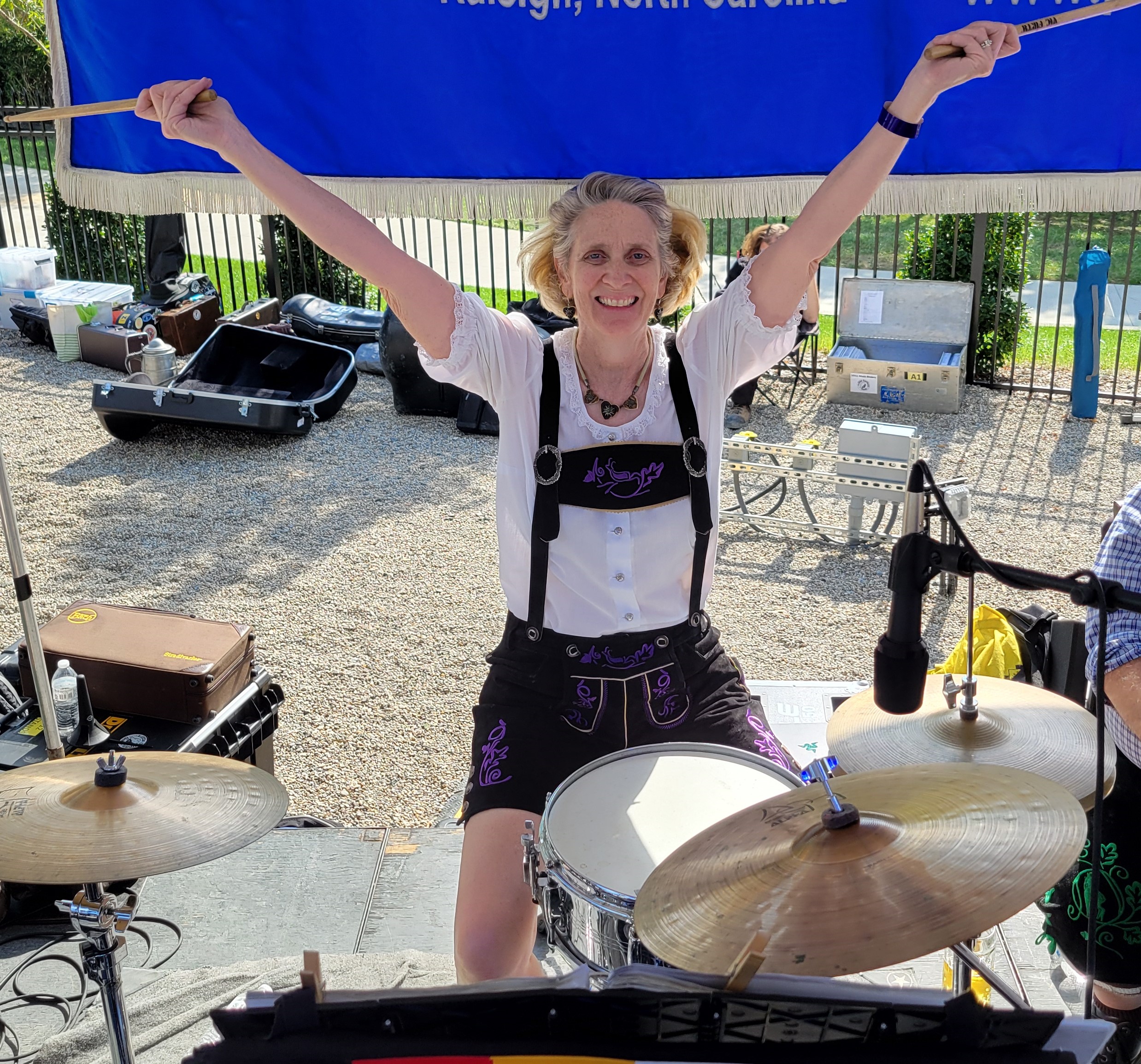 Cathy in lederhosen thrilled to be playing drums